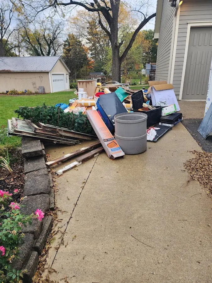 Dumpster being loaded with debris for Roofing Dumpster Rental in Lawrence